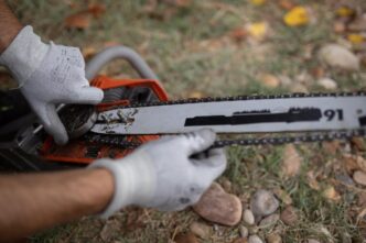 Technician adjusting a Stihl chainsaw in a workshop, showcasing craftsmanship and focus.